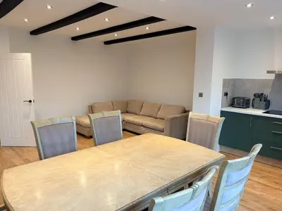 a living room with a table and a couch at Green Rig