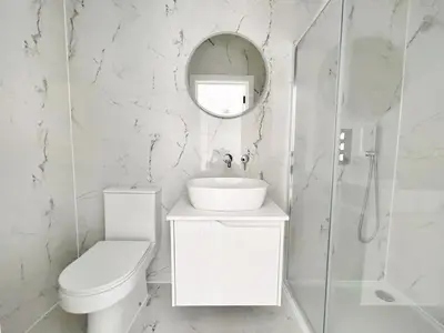 a bathroom with a toilet and a sink and a mirror at Green Rig