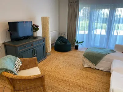 a bedroom with a bed and a tv on a dresser at Entire flat 2 to 4 pers 1 bed 1 bath disabled access for limited disability