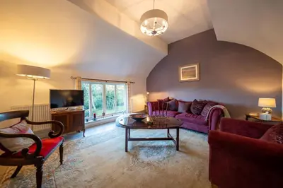 a living room with a couch and a table at The Old Rectory Framlingham in Framlingham