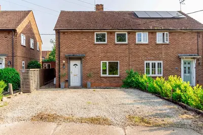 a brick house with a driveway in front of it at Beautiful 3 Bedroom Home with Parking & Garden in Colchester