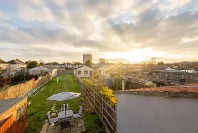 a view from the roof of a house with a yard at Spacious 3-Bed Home for 8 | Free Parking & Garden in Havering atte Bower