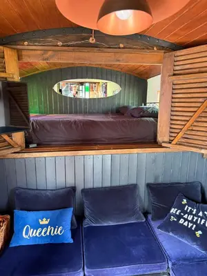 a room with a bed and two blue cushions at Rum Bridge Glamping and Fishing Resort in Clare