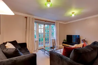 a living room with two couches and a tv at Stylish Modern Home in City Centre Free Parking - Pass the Keys in Cambridge