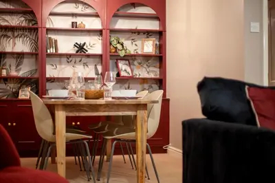 a dining room with a table with chairs and wine glasses at Stylish Modern Home in City Centre Free Parking - Pass the Keys in Cambridge