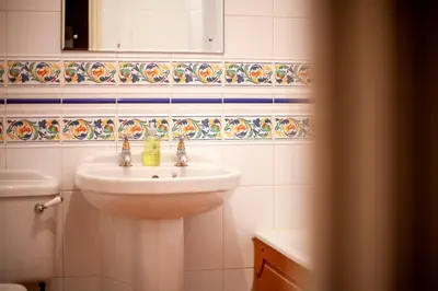 a white bathroom with a sink and a mirror at Stylish Modern Home in City Centre Free Parking - Pass the Keys in Cambridge
