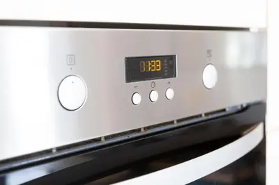a microwave oven with a clock on top of it at 5 Bed Seaside Property with Garden , Parking and Games Room in Southend-on-Sea