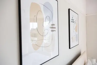 a room with two framed art prints on a wall at 5 Bed Seaside Property with Garden , Parking and Games Room in Southend-on-Sea
