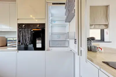 a kitchen with an open refrigerator in a kitchen at Luxury Apartment- Beach 10mins in Thorpe Bay