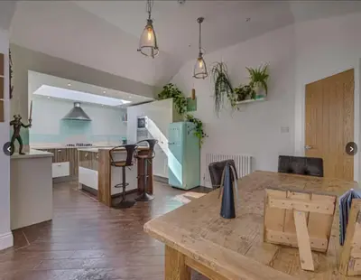 a kitchen with a wooden table in a room at Stunning home in Leigh Sleeps 5 - Pass the Keys in Southend-on-Sea