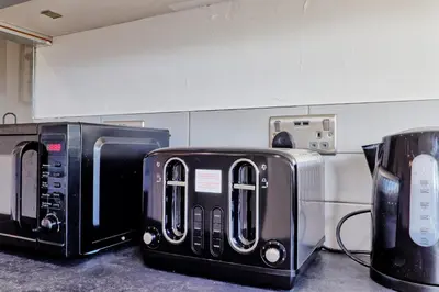 two toaster ovens sitting next to each other at Modern 4BR Sleeps 10, Free Parking, Basildon town, Contractor friendly in Basildon
