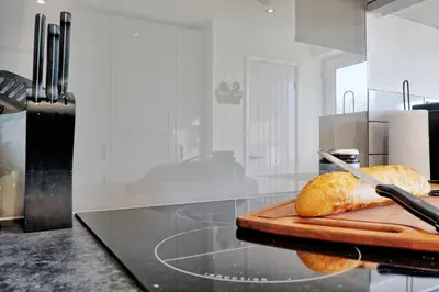 a loaf of bread on a cutting board on a counter at Modern 4BR Sleeps 10, Free Parking, Basildon town, Contractor friendly in Basildon