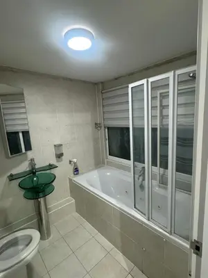 a bathroom with a tub and a toilet and a sink at Systematic Home in Battlesbridge