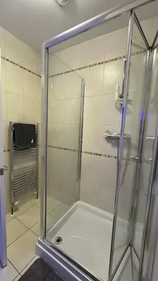 a shower with a glass door in a bathroom at 52A Flat Mill Road in Cambridge