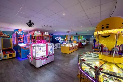 a room with many arcade games and other games at Suntrail House in Great Clacton