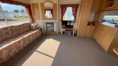 a living room with a couch and a tv at Suntrail House in Great Clacton