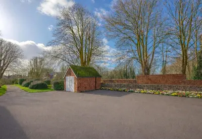 a small house with a green roof in a driveway at Louisville Flat 3 in Newmarket