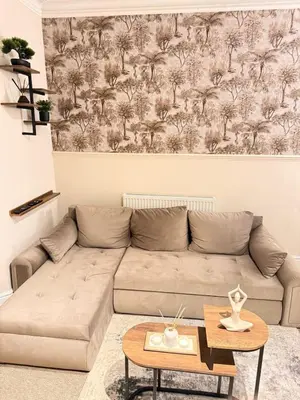 a living room with a couch and a table at The Coral Stay By Cambridge Central Station in Cambridge