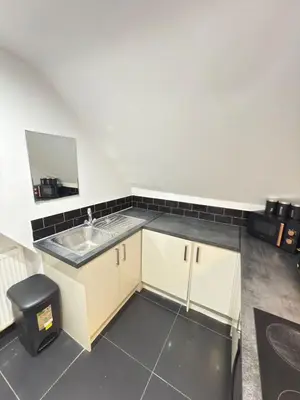 a small bathroom with a sink and a mirror at The Traveller's Nest by Cambridge Central Station in Cambridge