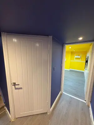 a room with a white door and a blue wall at The Squid Escape By Cambridge Central Station in Cambridge