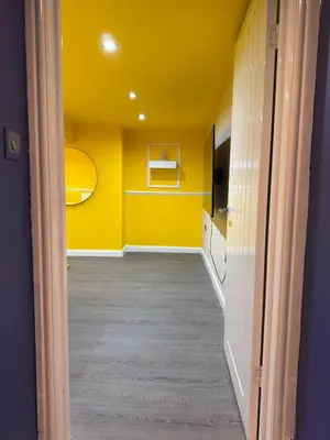 a hallway with yellow walls and a yellow ceiling at The Squid Escape By Cambridge Central Station in Cambridge