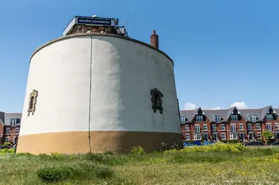 a large white tank sitting on top of a field at Serene Sands in Felixstowe