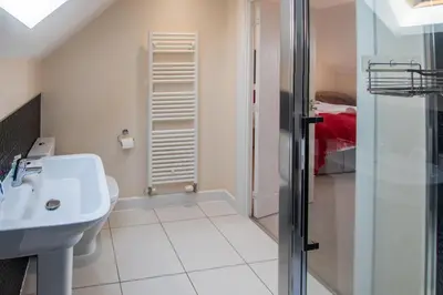 a bathroom with a toilet and a sink and a shower at Serene Sands in Felixstowe