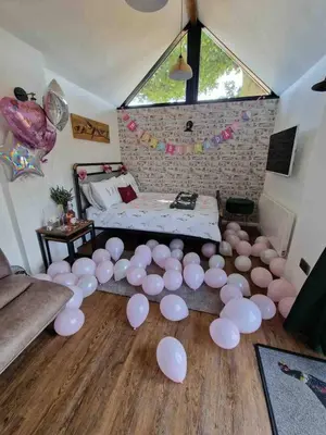 a room with a bed and a bunch of white balloons at The Acorn - Roudham Norwich in Norwich