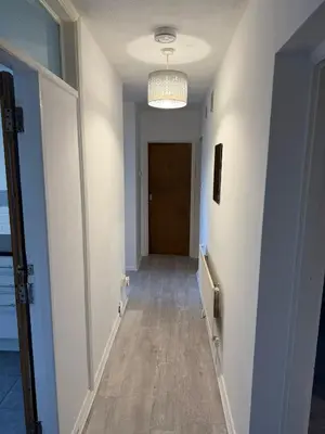 a hallway with a hallway leading to a door at Cozy 3 Bedroom Flat near Essex Uni, WiFi and Free Parking in Hythe