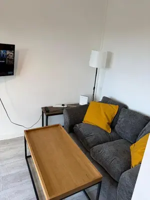 a living room with a couch and a table at Cozy 3 Bedroom Flat near Essex Uni, WiFi and Free Parking in Hythe