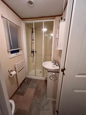 a bathroom with a shower and a sink at A & C Coastal Hideaway with outside Decking in East Mersea