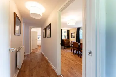 a hallway leading to a living room and a dining room at Idyllic, Private and Picturesque Cottage in Newmarket