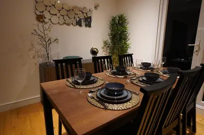 a dining room table with plates and glasses on it at Premium 3BR House - Loughton - by Rent Squared LTD in Loughton
