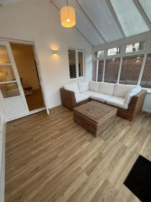 a living room with a couch and a table at The Waldegraves Hideaway in Bures Saint Mary