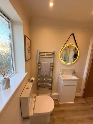 a bathroom with a white toilet and a mirror at The Waldegraves Hideaway in Bures Saint Mary