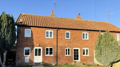 an old red brick house with white doors and windows at Beautiful Four Bedroom Cottage in Little Glemham, Suffolk in Little Glenham