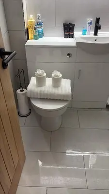 a bathroom with a toilet with two candles on it at Olivers retreat in Braintree