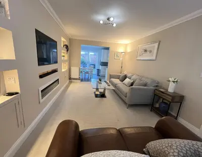 a living room with a couch and a tv at Siskin House in Wickham Market