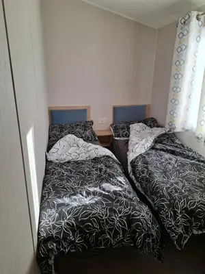 two beds sitting next to each other in a room at Life is Adventure in Great Clacton