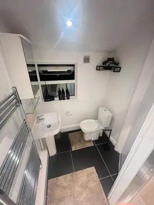 a bathroom with a white toilet and a sink at The Emerald Aura Stay By Cambridge Central Station in Cambridge