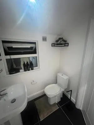 a bathroom with a white toilet and a sink at The Emerald Aura Stay By Cambridge Central Station in Cambridge