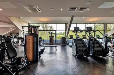 a gym with treadmills and elliptical machines at Finest Retreats - Heron Luxury Lodge