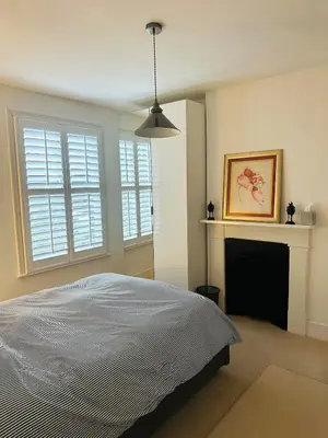a bedroom with a bed and a fireplace at Central Cambridge with Free Parking and Pets welcome in Chesterton