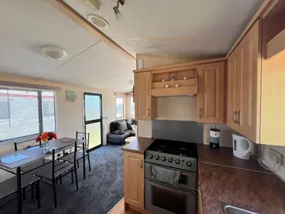 a kitchen and dining room with a table and a kitchen and a dining room at Rohannah A and C Ultimate Retreat in Colchester
