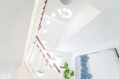 a white room with a staircase and a window at Emerson Park Villa, Heated Pool, Hot Tub, Cinema in Harold Wood