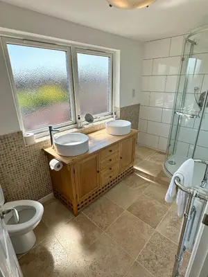 a bathroom with two sinks and a shower and a toilet at Detached, 5 Double Bedrooms, 3 En-Suites, 5 Car Parking in Lexden