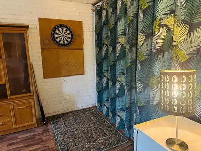 a room with a wall with a clock on the wall at Family Country Home in Stoke Ferry
