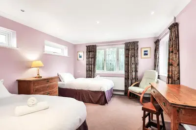 a bedroom with two beds and a desk and a table at 2-Bed Home with Free Parking - 2 min Walk to Bus in Cherry Hinton