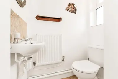 a white bathroom with a sink and a toilet at 2-Bed Home with Free Parking - 2 min Walk to Bus in Cherry Hinton