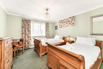 a bedroom with two beds and a desk at 2-Bed Home with Free Parking - 2 min Walk to Bus in Cherry Hinton
